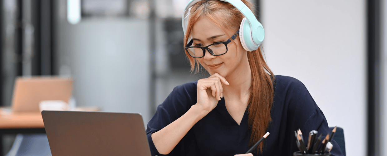 asian woman smiling looking at laptop