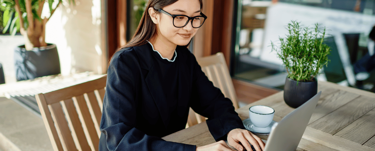 asian woman young adult writing on laptop