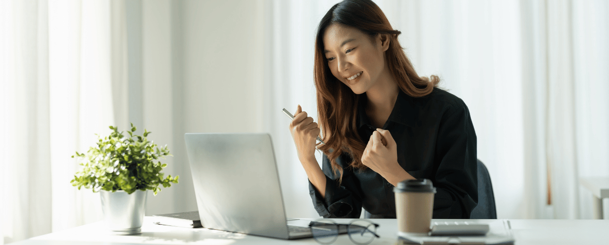 asian woman happy on laptop