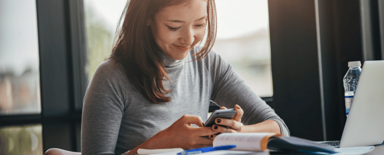 asian woman reading at her phone