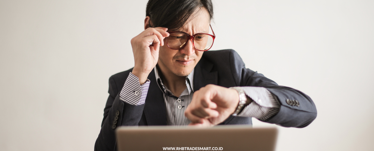 asian-man-working-looking-at-watch